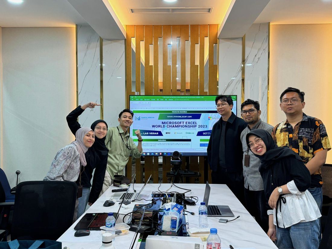 Adam with the ASKRINDO team in front of the Microsoft Excel World Championship case